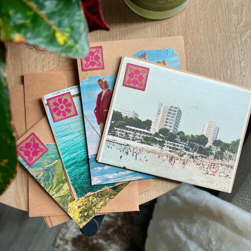 four colorful greeting cards displayed on a wood table